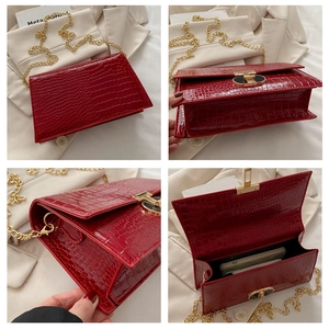 Detailed four-way view of red crocodile pattern chain bag with golden swivel lock