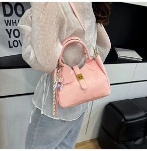 Fashionable pink lychee grain leather bucket bag shown in a chic lifestyle setting