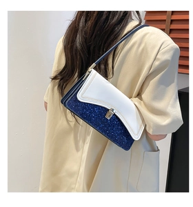 Close-up of the blue sequin and white leather contrast on the trendy underarm bag