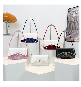 Detail shot of multi-color crossbody bags featuring glitter patchwork and gold metal buckles
