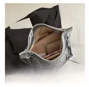 Interior view showing large capacity and internal storage of the silver metallic shoulder bag