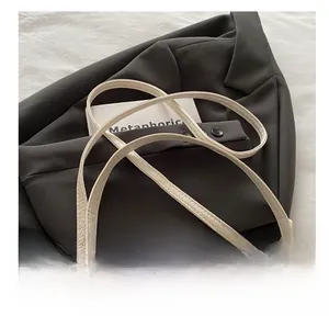 Detail shot of the white quilted handbag featuring a durable adjustable shoulder strap