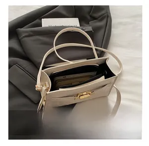Detail view of the open white crocodile embossed handbag showing spacious interior capacity
