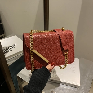 Brick red woven texture crossbody bag with gold chain strap and metallic buckle