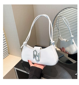 Détail du sac sous l'aisselle en cuir PU blanc avec logo argenté et sangle nouée