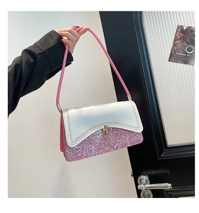 Detail view of pink glitter and white leather contrast bag with gold wavy stitching