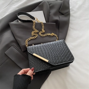 Fashionable black woven chain shoulder bag with elegant gold metal buckle closure