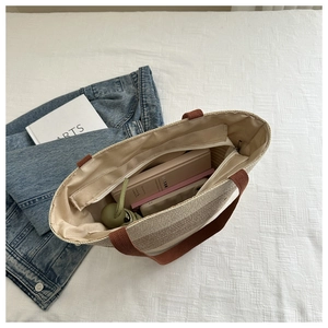 Top view of woven cotton rope tote bag showing zipper closure and spacious interior lining