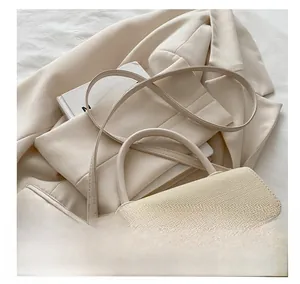 Detail of beige woven texture bag with golden hardware on elegant suit background