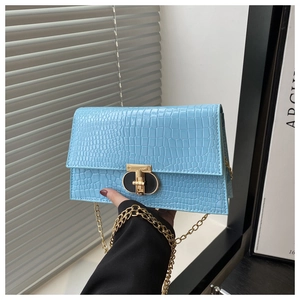 Light blue croc-embossed chain crossbody bag with golden lock and sleek stone texture