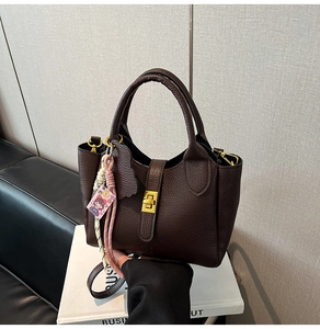 Sophisticated brown lychee grain leather bucket bag with gold hardware accents