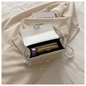 Detail showing high-capacity interior of contrast color handbag with phone and wallet