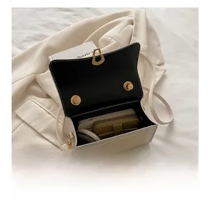 Interior view of contrast color crossbody bag showing capacity for phone and wallet