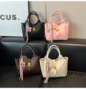 Detailed view of litchi pattern bucket bags in black, pink, brown and cream white
