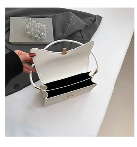 Overhead view showing the double-layer interior and silver sequin texture of the handbag