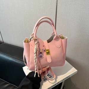 Elegant pink litchi grain bucket handbag for women with gold hardware and charm