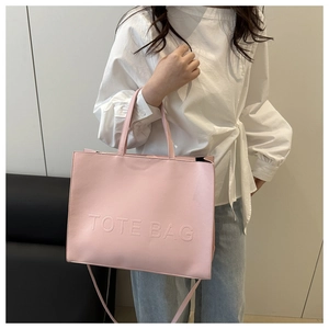 Pink large capacity tote bag with embossed lettering and detachable shoulder strap detail
