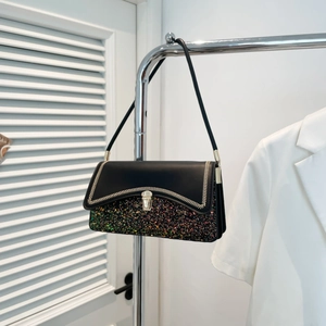 Fashionable black shoulder bag with sequins, stitching details and golden lock