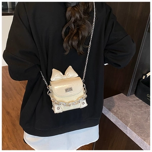 Detail of cream bow-knot crossbody bag with woven texture and silver twist lock