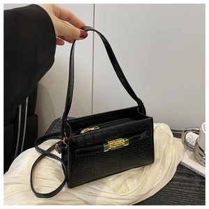 Close-up of black crocodile pattern leather texture with golden metal buckle and zipper