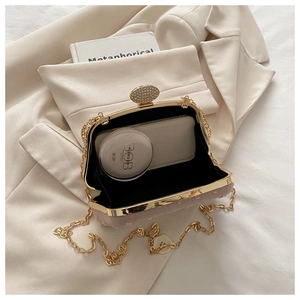 Interior view of light pink sequined evening clutch with gold chain and diamond buckle