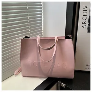 Pink tote bag detail with embossed lettering on high-quality matte leather material