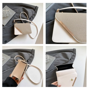 Détail d'un sac bandoulière bicolore avec fermoir magnétique et rabat à texture tissée