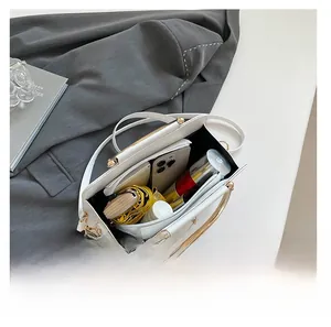 Macro view of large white leather tote bag showcasing its spacious interior capacity