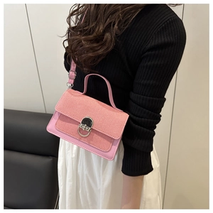 Pink patchwork crossbody bag with textured weaving and circular metal lock detail