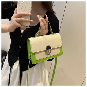 Detail view of lime green leather and beige woven fabric stitching on a small square bag