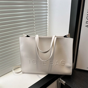 Minimalist white leather tote bag with embossed lettering and light shadow detail