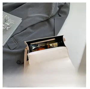 Interior view of off-white PU shoulder bag showing space for phone and makeup
