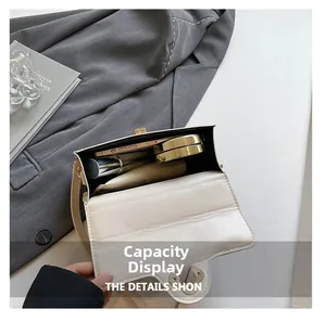 Interior view of minimalist crossbody bag holding a smartphone, cushion and lipstick