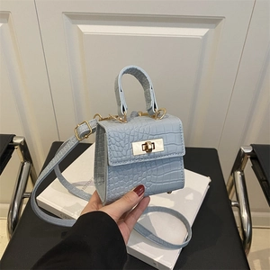 Light blue croc-embossed mini tote bag with gold twist lock and top handle