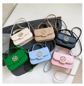 Selection of vibrant mini crossbody bags with gold M hardware in multiple stylish colors