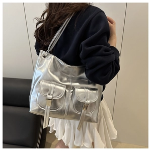 Detailed back view of a silver metallic tote bag featuring dual front pockets and flaps