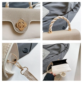 Detailed view of beige woven handbag featuring a vintage gold floral clasp and braided handle