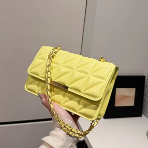 Minimalist bright yellow crossbody bag with geometric quilting and gold chain strap