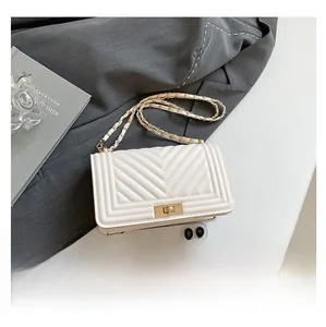 Detailed comparison showing interior capacity and golden lock of the white quilted crossbody bag