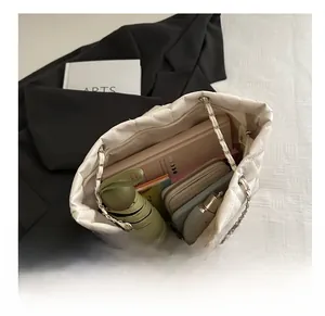 Internal view of the white quilted bucket bag showing large capacity for daily essentials
