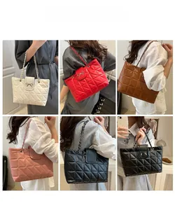 Quilted tote bags in various colors featuring metal bow clasps and chain straps