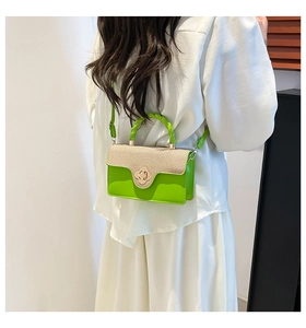 Detail of neon green handbag with beige woven texture, floral gold lock and model display