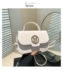 Detail of cream white PU leather handbag featuring a gold M-letter swivel lock and handle