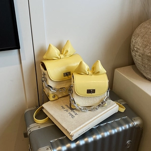 Yellow woven straw crossbody bag with bow detail and silver chain strap set