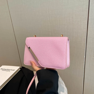 Pink patchwork crossbody bag with textured canvas and silver metal flap detail
