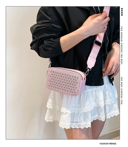 Pink rhinestone handbag with wide fabric strap shown in a cross-body lifestyle view