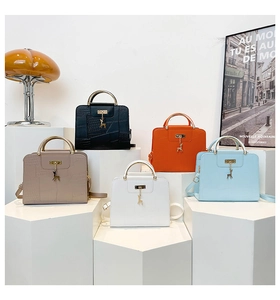 Close-up of luxury croc-embossed handbags in five colors with metallic deer charms