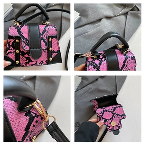 Detail view of pink snake pattern handbag featuring gold studs and metal magnetic buckle