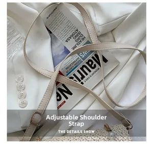 Close-up of beige woven handbag detail showing the adjustable leather shoulder strap