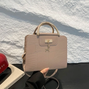 Beige minimalist crossbody bag with crocodile texture and gold deer pendant handle